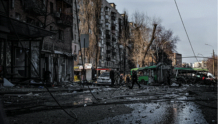 شارع مدمر في مدينة أوكرانية بعد غارة جوية، مع حافلة متضررة ومبانٍ سكنية متضررة وحطام متناثر في المكان